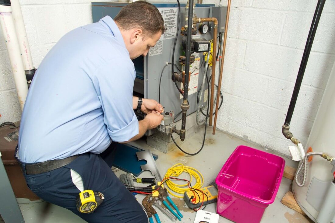 Picture of a man repairing the heating system